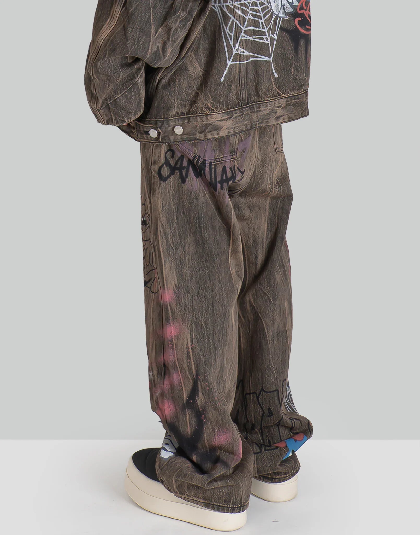 BUMPY GRAFFITI PRINT DISTRESSED DENIM PANTS