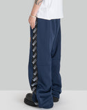 STACKED TRACK PANTS