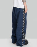 STACKED TRACK PANTS